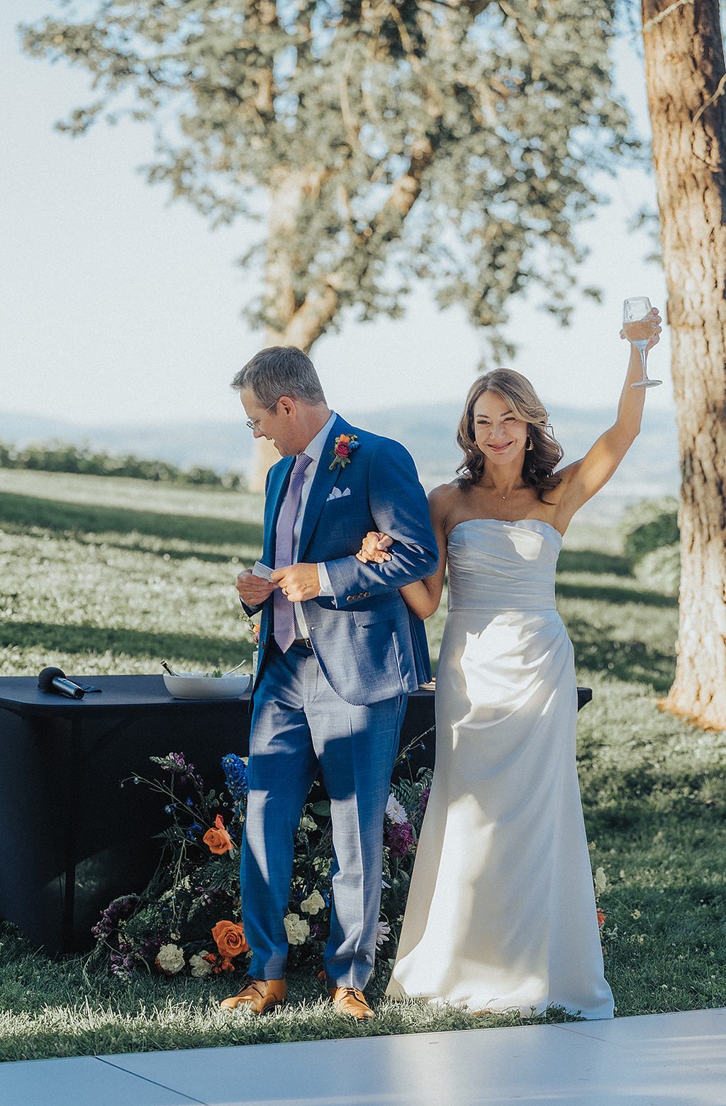 Bride raising a toast on the ceremony lawn.