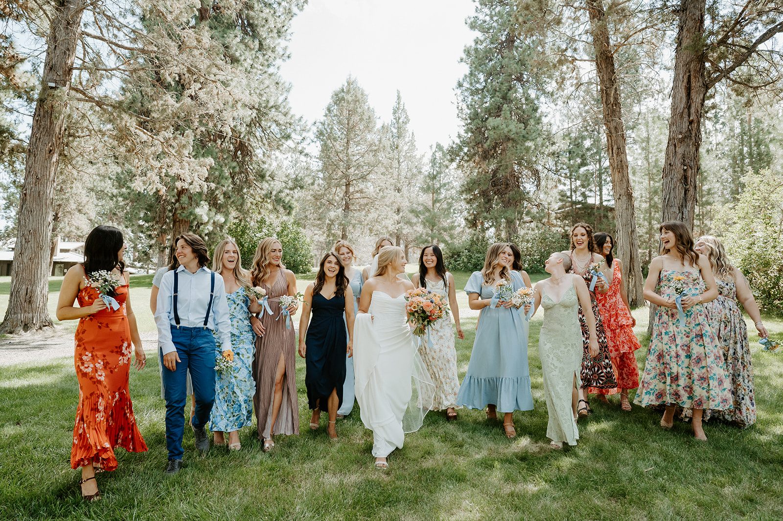 Wedding party walking through the pines at Rock Springs Ranch.