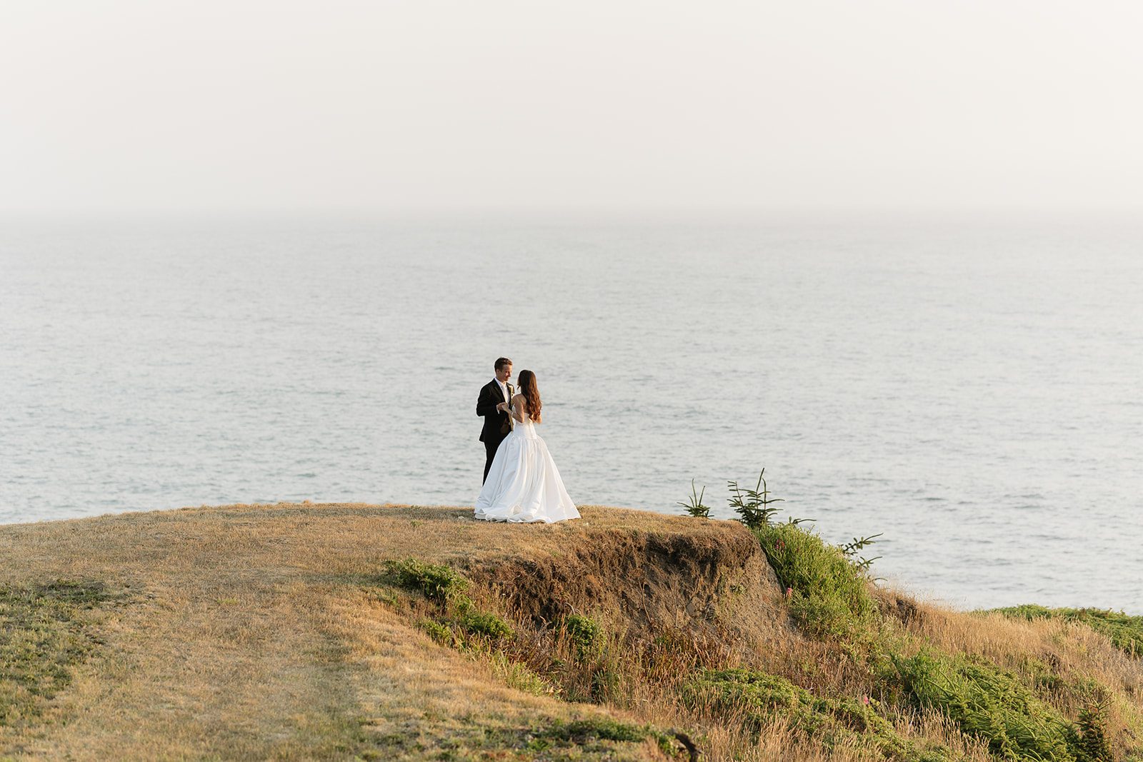 Couple on an ocean bluff at Crook Point above the Pacific.