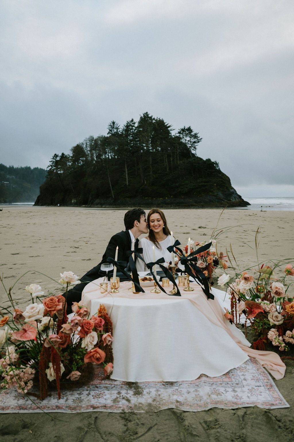 Sweetheart picnic table with florals on the beach.